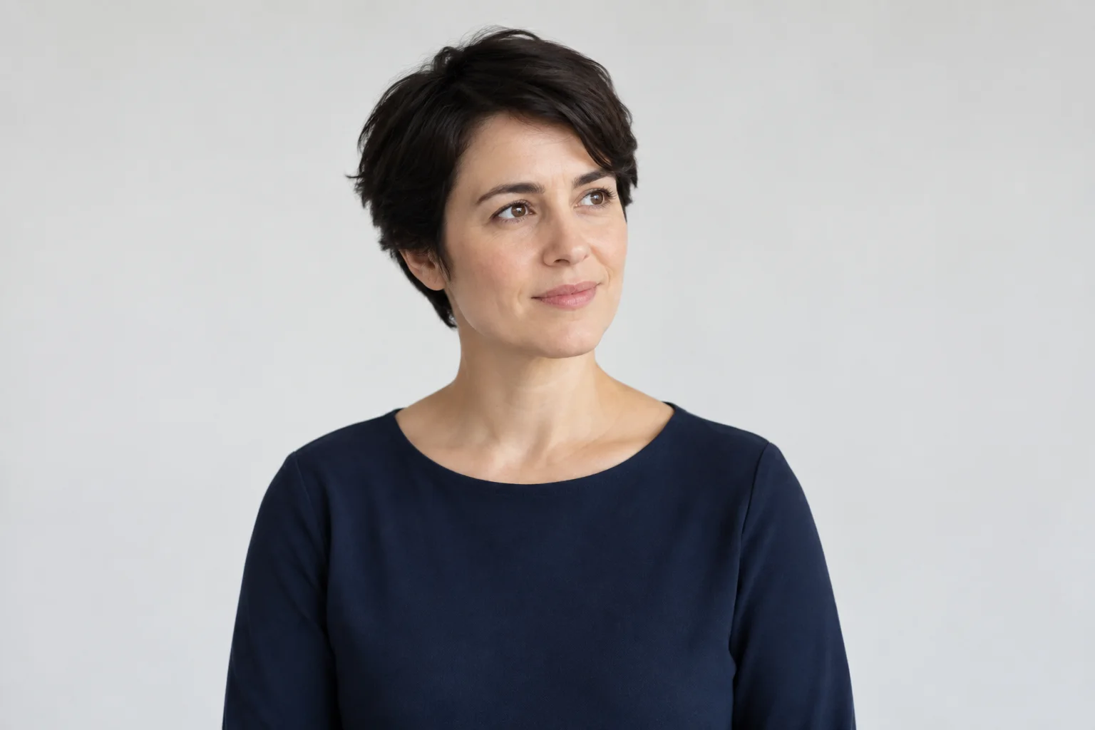 Portrait of a script writer in a navy top against a plain background.
