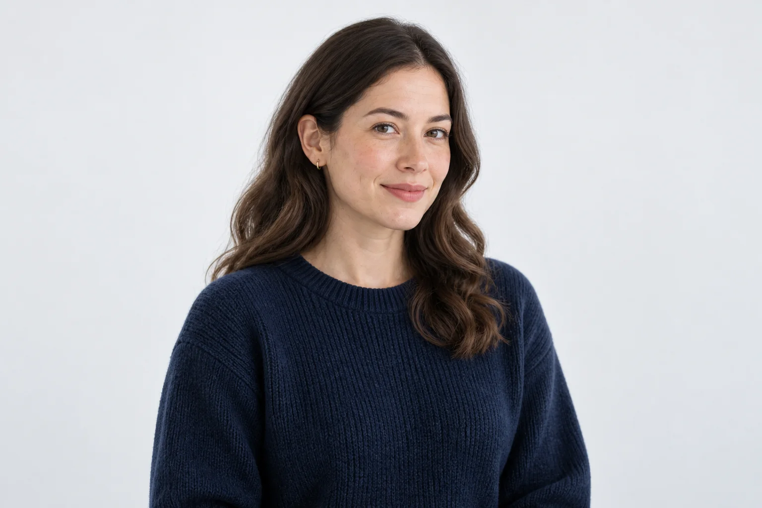 Portrait of a product specialist in a navy knit top against a plain background.